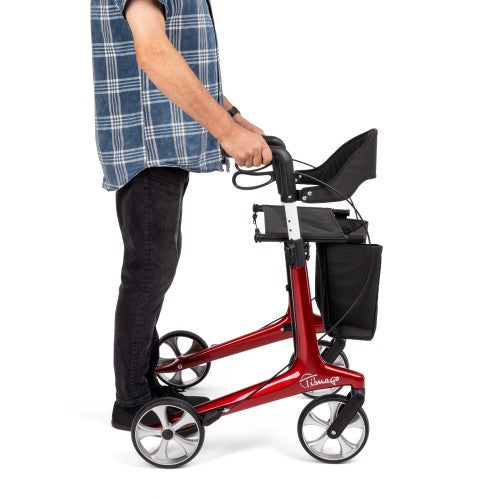 Red rollator being used by a person on a white background